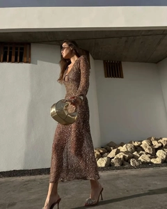 Detail shot of the sequined mesh fabric and elegant V-neckline of this brown gold maxi dress