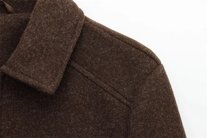 Macro shot of dark brown wool jacket collar showing detailed texture and stitching