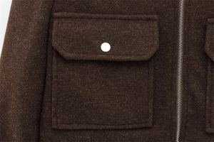 Close-up of deep brown wool blend jacket with flap pocket, metal button and zipper