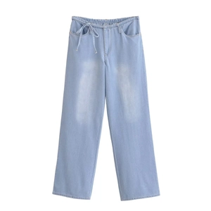 Detail of light blue wide-leg denim jeans with elastic drawstring waist and pockets