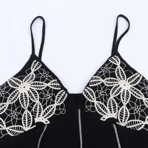Elegant black camisole dress featuring white floral embroidery and thin straps