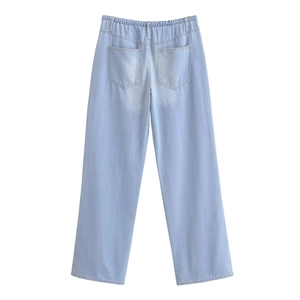 Detail view of high waist elastic waistband and back pockets on light blue wide leg jeans