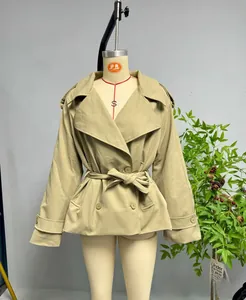 Detail of khaki trench coat with adjustable waist belt and classic lapel design