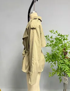 Side view of a beige trench coat featuring a belted waist and classic epaulettes detail