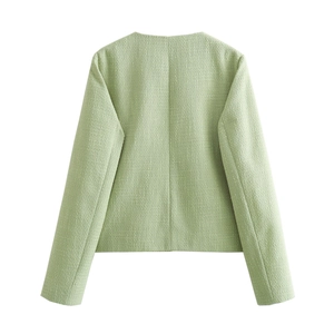 Rear view of a light green tweed jacket for women showing refined woven texture