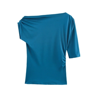 Détail du haut asymétrique bleu canard avec manches décalées et fronces sur le côté
