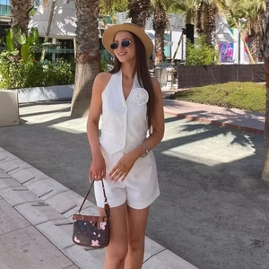 White two-piece halter vest suit with 3D floral decoration and high-waisted shorts