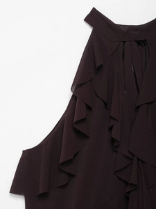 Detail of burgundy halter neck top featuring tiered ruffle layers and textured fabric