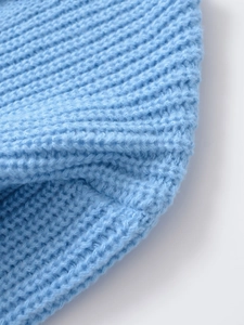 Close-up of light blue rib-knit fabric texture on the casual women long sleeve sweater
