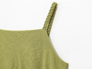 Detailed close-up of woven braided shoulder strap on grass green summer dress