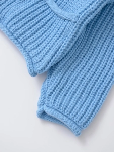 Close-up of sky blue knit cardigan showing detailed ribbed texture and soft fabric finish