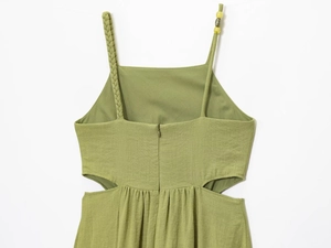 Detail view of grass green dress with braided straps and side cut-outs in linen texture