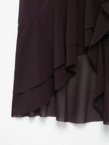 Detail of multi-layered ruffle hem on elegant dark purple sleeveless halter top