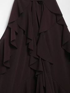 Close-up of layered burgundy ruffles and fine textured fabric on a halter top