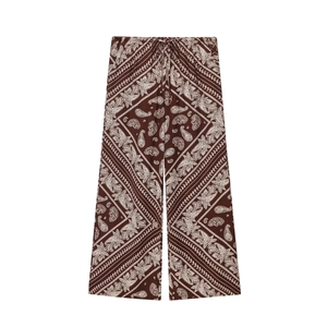 Brown wide-leg trousers with white paisley prints and elastic drawstring waist for vacation