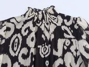 Detail of smocked high neck floral chiffon top with gold lurex metallic thread