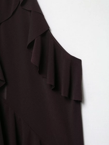 Detailed close-up of the elegant ruffled neckline on this autumn burgundy halter top
