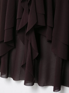 Detail view of layered burgundy chiffon ruffles with a delicate translucent texture