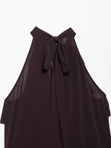Detail of burgundy halter neck top featuring elegant bow tie closure on the back
