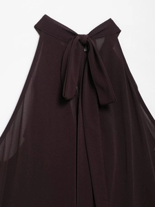 Detail of burgundy chiffon halter top showing the delicate bow tie and draped neckline