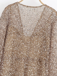 Detailed macro view of champagne gold sequin mesh fabric with a stylish V-neck design