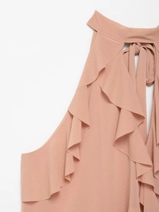 Detailed view of dusty rose halter top with elegant ruffled layers and textured fabric