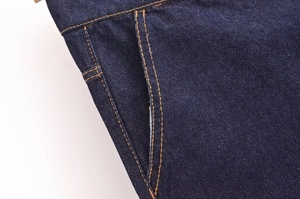 Detail of dark blue denim shorts with contrast orange stitching and side pocket design