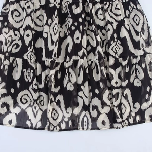 Elegant chiffon maxi dress with black and white tribal prints and tiered ruffled details