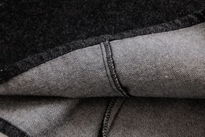 Close-up of deep blue denim fabric texture and high-quality industrial stitching detail