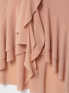 Detailed macro view of layered chiffon ruffles on dusty pink neck sleeveless top