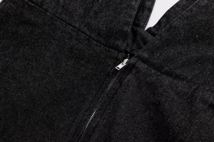 Close-up of a silver metal zipper on premium black denim fabric for a summer dress