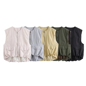 Detail of multi-color sleeveless vests with utility pockets and pleated hem design