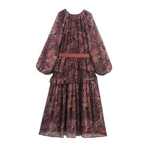 Detail of burgundy paisley print dress with tiered ruffles and slim brown waist belt