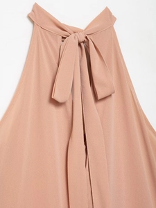 Detail of elegant halter neck top with chiffon ribbon bow tie at the back