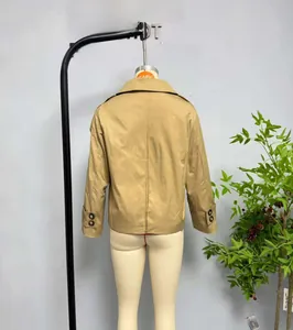 Detail view of khaki trench coat back featuring classic epaulettes and buttoned cuffs