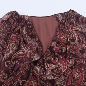 Bohemian paisley print V-neck dress with layered ruffle details in deep burgundy tones