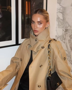 Detail of khaki double-breasted trench coat with wide lapels and marbled buttons