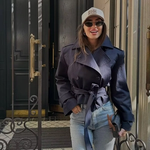 Navy blue short trench coat for women featuring a double-breasted design and waist belt