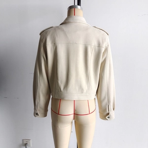 Detail of back seams and shoulder straps on a beige faux suede jacket for women
