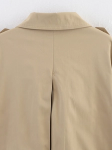 Detail view of khaki trench coat back with epaulets and decorative central pleat
