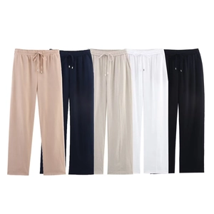 Detail view showing drawstring elastic waistbands on linen blend wide leg trousers