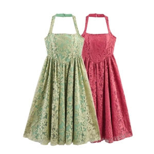 Detail of floral lace texture on elegant halter neck dress in green and pink colors