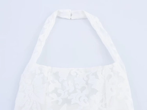 Close-up of white floral lace halter dress neckline with intricate 3D embroidered details
