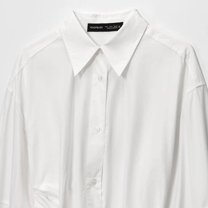 White cotton shirt dress with classic pointed collar and long sleeves for summer 2025