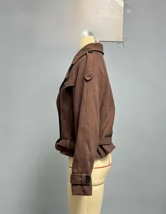 Detail of dark brown wool jacket featuring large lapels, shoulder tabs and waist belt