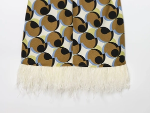 Detail of the feather fringe hem on a geometric print dress with vintage pattern