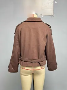 Detail view of brown wool jacket with classic epaulets and buckled waist strap on back