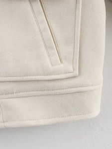 Detailed close-up of cream faux suede jacket showing premium stitching and fabric texture