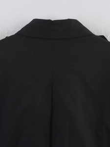 Detailed close-up of the back collar and stitching of a black double-breasted trench coat