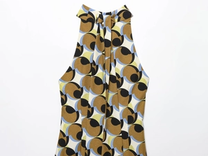 Detail of halter neck top featuring vintage geometric patterns and pleated tie neckline